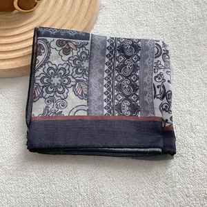 Detail of vintage paisley cotton linen square scarf with elegant bohemian floral patterns