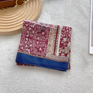 Close-up of floral pattern cotton scarf with red and blue vintage ethnic patchwork print