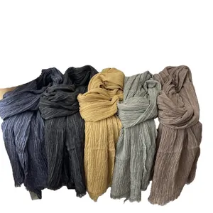 Solid color cotton-linen feel scarves in multiple tones with soft pleated texture