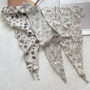 Three 100% linen triangle scarves with delicate floral prints in natural off-white