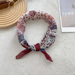 Detail shot of vintage cotton linen scarf with bohemian paisley and floral pattern texture