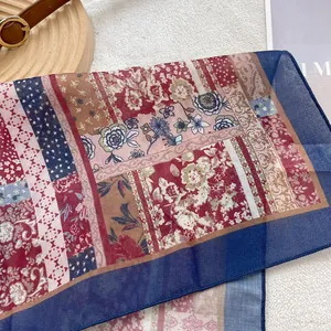 Detailed view of dark red retro floral cotton scarf on a magazine and fur background