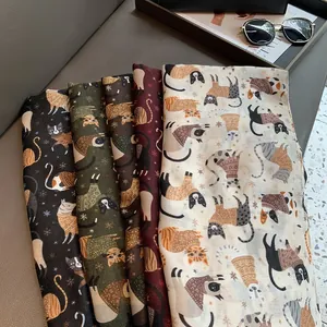 Detail of four colorful linen scarves with cute cat prints and snowflake patterns