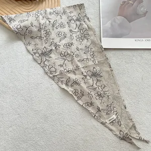 Close-up of vintage floral print 100% linen headscarf with material detail tag
