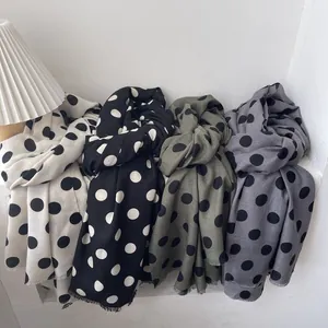 French vintage polka dot long scarves in four colors displayed on a window sill