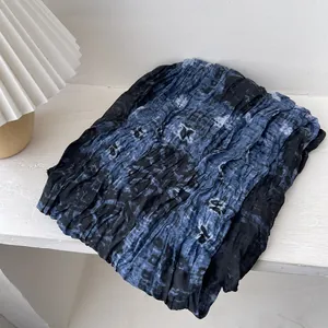 Vintage pleated scarf with blue and black tie-dye pattern on textured cotton linen fabric