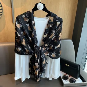 Detailed close-up of a black cotton scarf featuring colorful cartoon cat and moon prints