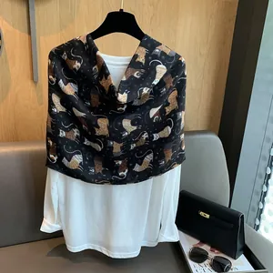 Detail of soft white cotton top paired with a black scarf featuring hand-drawn cat patterns