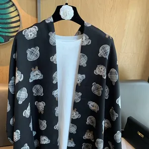 Detail of cartoon teddy bear print with classic check pattern on black linen cotton scarf