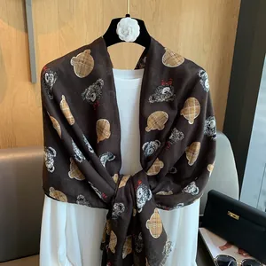 Detailed view of dark brown cotton-linen scarf with teddy bear and classic plaid patterns