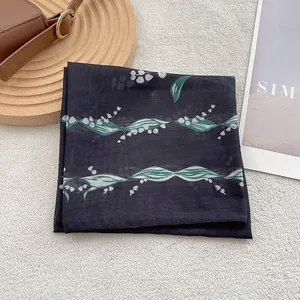 Breathable cotton linen scarf with lily of the valley print on a black background