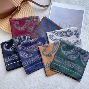Elegant paisley square scarves collection in seven colors on soft white carpet background