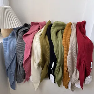 Knitted shawl scarf in ten vibrant colors with soft ribbed texture and brand tag
