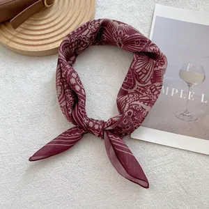 Vintage burgundy silk-textured square scarf with floral prints on white faux fur background