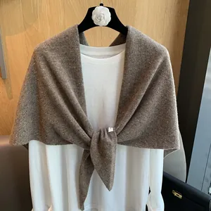 Detailed texture of brown wool knit shawl with colorful speckled tweed pattern