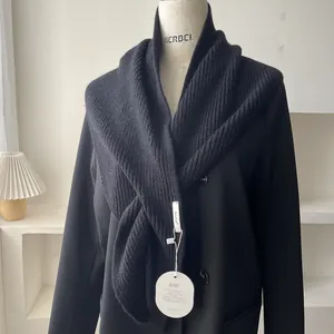 Minimalist black knit shawl wrap with vertical stripe texture on a stylish blazer
