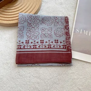 Vintage light blue and maroon paisley square scarf displayed on white fleece background