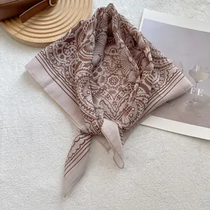 Detail of vintage mandala pattern scarf on white faux fur with magazine and leather strap