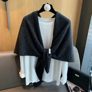 Charcoal grey 100% wool knitted triangle scarf with colorful flecks shown tied over white top