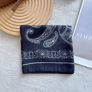 Close-up of black beige paisley square silk scarf with elegant lace border pattern