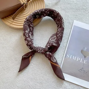 Brown silk scarf with white paisley pattern and flower print in a stylish knot