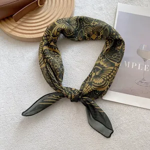 Close-up of vintage butterfly totem silk scarf tied as a necktie in gold and black