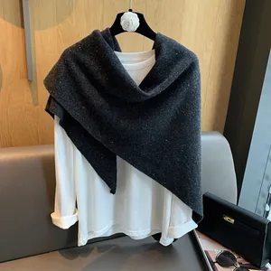 Detail of dark grey 100% wool triangle scarf with white speckled texture and thick fabric