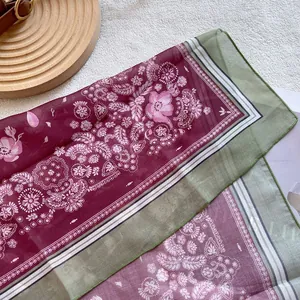 Close-up of paisley silk scarf with daisy pattern and fine machine-stitched edges