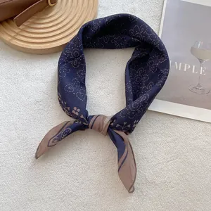 Detail of dark blue vintage paisley square scarf with silk texture and floral print
