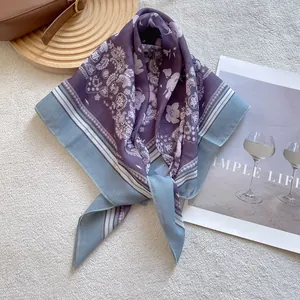 Detail of paisley square scarf in purple and grey blue on a white texture background