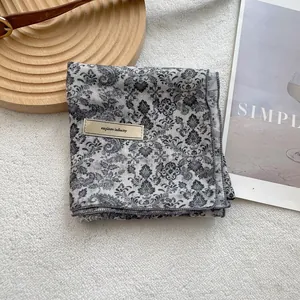 Detail of vintage square neck scarf with paisley pattern and explore infinity tag
