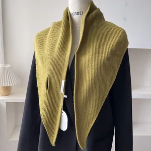 Detail of olive green knit scarf with vertical ribbed texture and slit closure