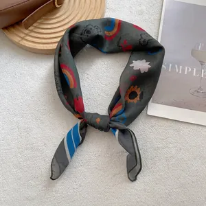 Detail of silk-like scarf featuring colorful bear and flower prints with a premium finish
