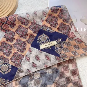 Retro paisley floral linen scarf with explore infinity label on minimalist background