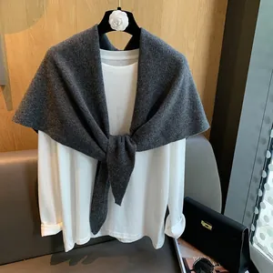 Elegant dark grey hollow knit triangular scarf shawl draped over a white long sleeve shirt