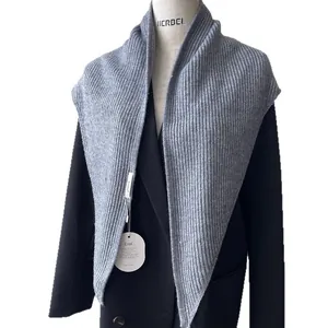 Chic grey ribbed knit shawl scarf layered over a black coat for an elegant look