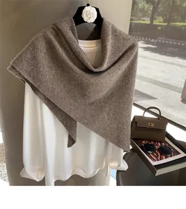 Detail of premium brown 100% wool knit shawl with soft texture and chic styling