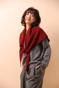 Close-up of deep red hollow knit texture on a luxury triangle shawl for women