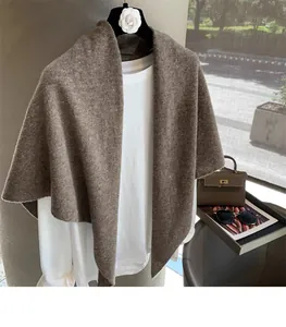 Detail of coffee brown wool knit shawl showing thick texture and warm earthy tone