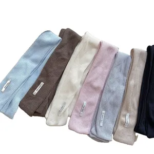 Handmade knitted skinny scarves in seven colors including blue, beige and pink