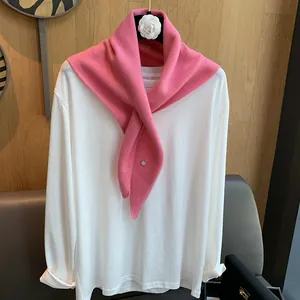 Detail of pink wool neckerchief with metallic accent on white basic long sleeve shirt