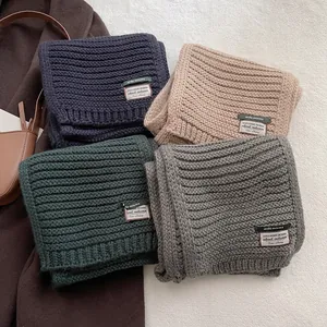 Knitted wool blend winter scarves in four colors with thick ribbed texture and brand tags