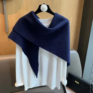 Close-up of the textured dark blue hollow knit shawl paired with a white basic T-shirt