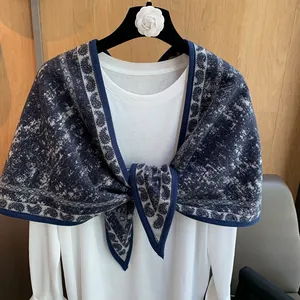 Detailed close-up of dark blue and white vintage knitted shawl with intricate patterns