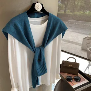 Peacock blue wool knit shawl layered over a white long sleeve top for autumn fashion