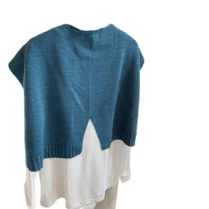 Teal wool-blend knit shawl with back slit layered over a white long-sleeve shirt