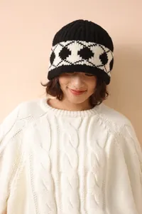 Close-up of thick 100% wool knit bucket hat featuring a vintage black and white diamond pattern