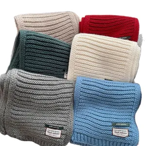 Classic wool blend knit scarves in assorted colors with ribbed texture and woven labels