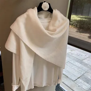 Close-up of pure white wool blend crossover shawl showing soft plush texture and knitting