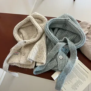 Knitted balaclava hood scarf with chunky rib texture and button closure in beige and blue
